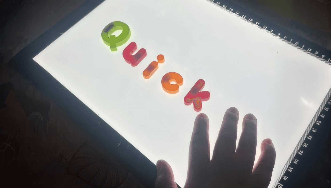 A young child working on a tablet in a wheelchair