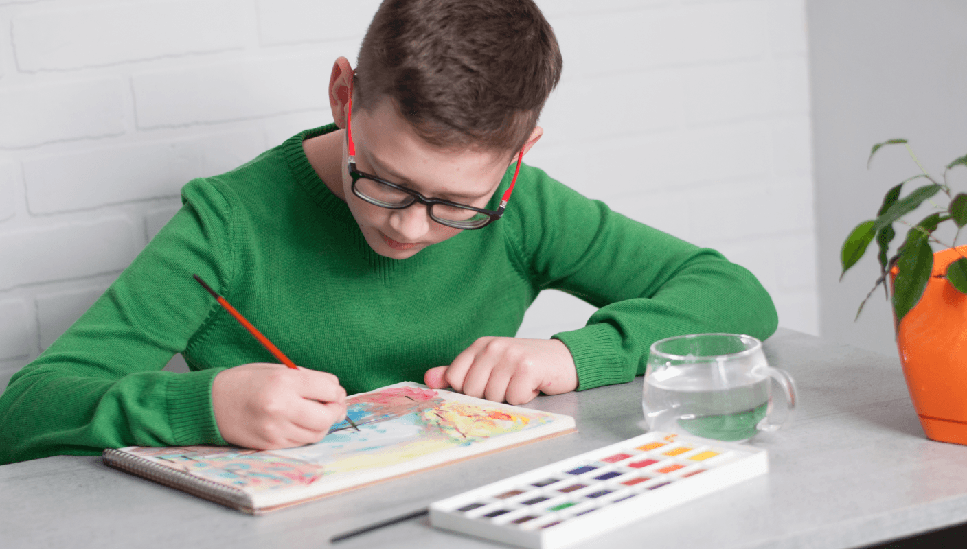 A young child working on a tablet in a wheelchair