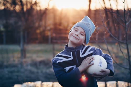 child playing football outdoors