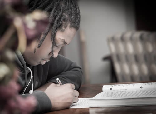 boy writing in class