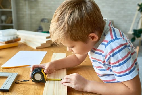 boy doing some woodwork