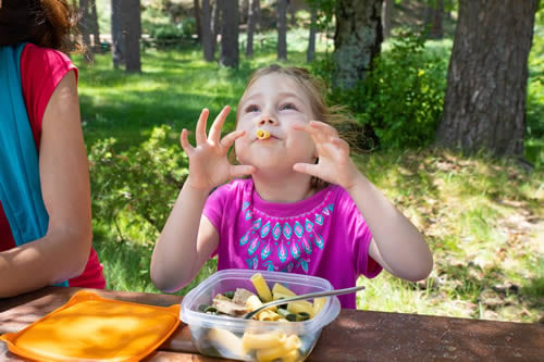 child eating from her lunchbox