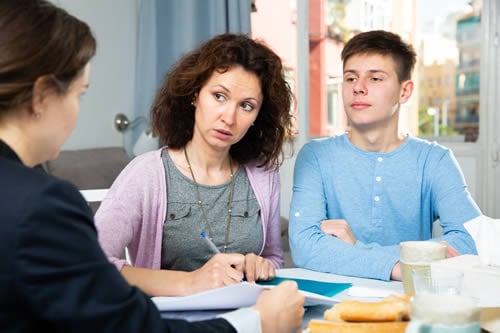 parent talking to a teaher with pupil