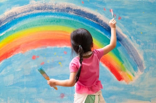 child painting a rainbow