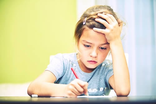 child visibly struggling to write