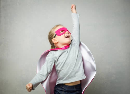 child punching the air with confidence