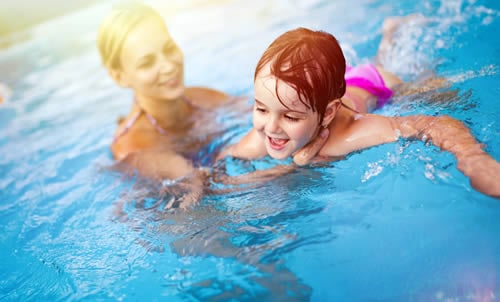 child swimming with mother