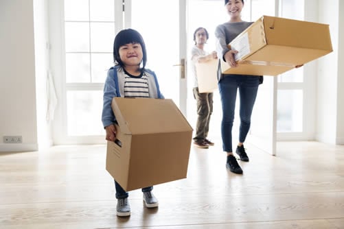 children helping to carry boxes