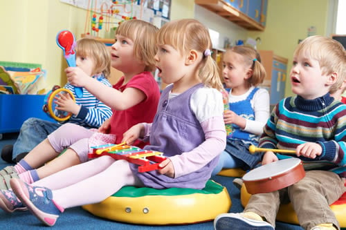 children in the classroom making music together