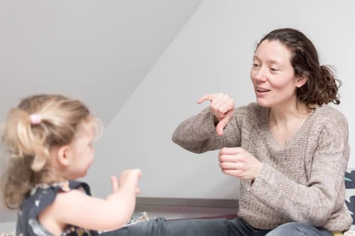 child with hearing loss learning from a tutor