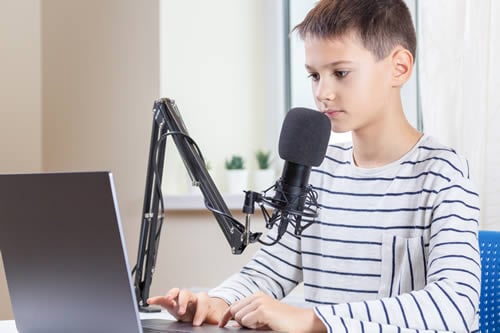 dyslexic child using a laptop to use voice to text