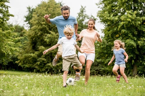 family playing football for wellness