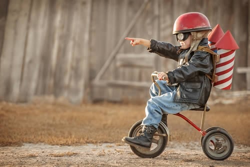 child on a pretend rocket bike