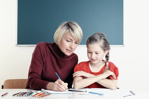 child improving her maths with tutor