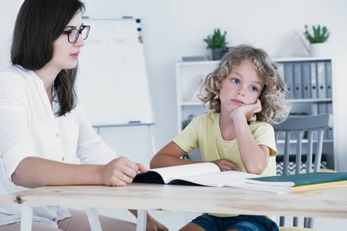 special needs tutor being patient with child