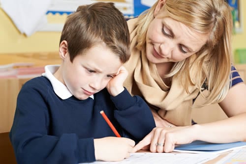 teaching assistant with school child