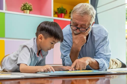 teacher engaging with young male student