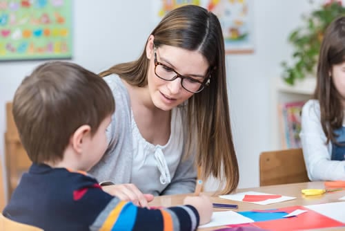 teacher helping child