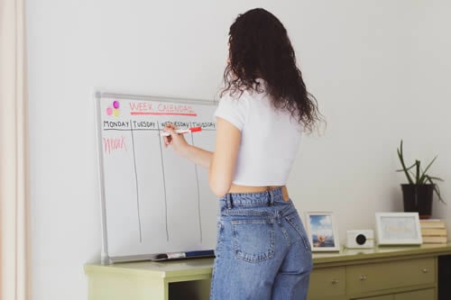 teacher writing schedule on white board