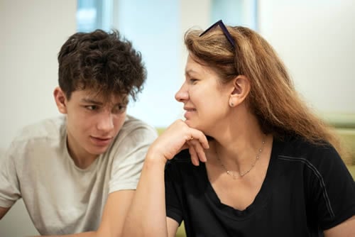 Mum giving praise to teenager