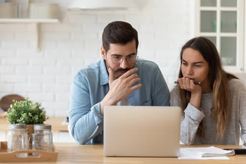 adults researching on laptop