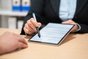 Close up of teacher holding a pen with digital tablet