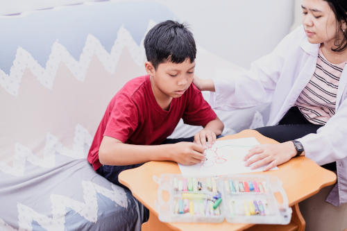 Letting autistic boy regulate himself in a room colouring