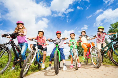 children on bikes together on a path