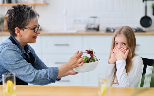 tmum testing out new food with child in fun way