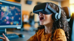 girl wearing a virtual reality headset engages with technology in a vibrant classroom. Her excitement reflects a positive learning experience using innovative tools.