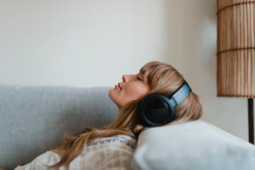 woman relaxing with headphones listening to music