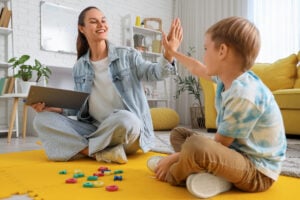 SEND tutor helping dyslexic child to learn using alphabet letters