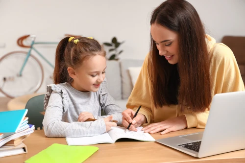 A girl learning with her sen tutor.