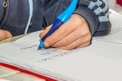 dyslexic child writing in notebook