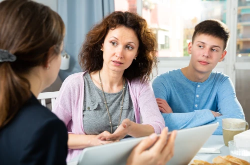 parent and home-schooled child in support meeting with local authority