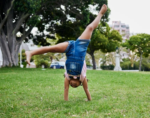 child doing a cartwheel outside
