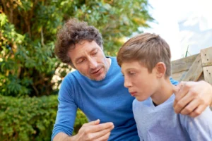 child being supported by his parent in summer